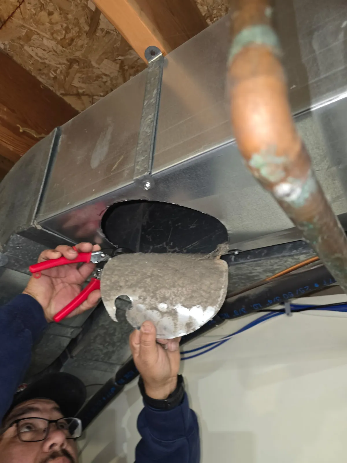 Technician Carlos working on ductwork